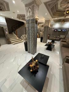 a lobby with couches and tables in a building at Hotel Mounia in Fez