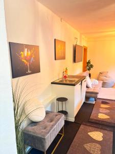 a living room with a kitchen with a counter and a table at Apart TYROL in Finkenberg