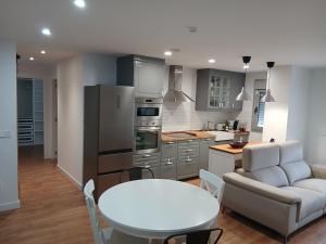 a kitchen with a white table and a white couch at Costa verde asturiana - VUT4692AS in El Espín