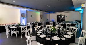 a room full of tables and chairs with plates and flowers at Mia Reef Isla Mujeres - All Inclusive Resort in Isla Mujeres