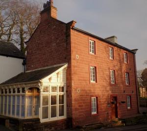 an old red brick building with white windows at Barrowgarth Guest House in Appleby