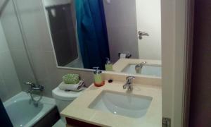 a bathroom with a sink and a toilet and a mirror at depto nuevo temuco in Temuco +16 photos