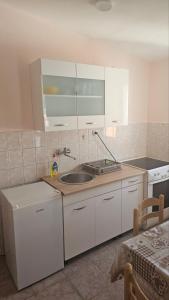 a kitchen with a sink and a counter top at Apartman Andrej in Bar