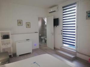 a white room with a toilet and a window at AlbaChiara B&B in Gaeta