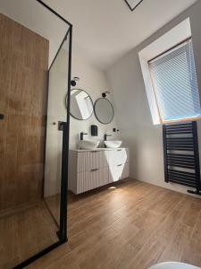 a bathroom with two sinks and a mirror at Laguna Blue in Grzybowo +22 photos