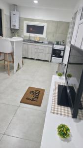 a kitchen with a table and a counter top at VMV Departamento in Río Grande