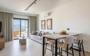 a living room with a table and a couch at Serenya Hotel Milos in Adamantas