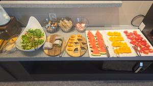a table with many different types of food on it at HOTEL lantana in Tudomi