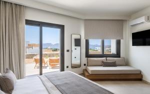 a bedroom with a bed and a sliding glass door at Serenya Hotel Milos in Adamantas +61 photos