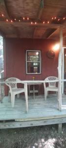 a patio with two chairs and a table and a window at Thunder Ridge Cabins B&B - Bird Nest in Rockbridge +1 photo