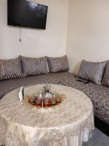 a living room with a table and a couch at Maison Traditionnelle in Casablanca