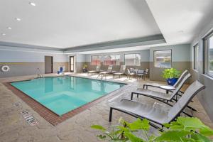 a pool in a hotel room with chairs and tables at Best Western Plus Big Lake Inn in Big Lake
