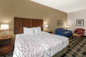 a hotel room with a bed and a blue chair at Best Western Plus Big Lake Inn in Big Lake +35 photos