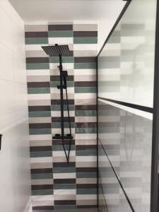 a room with a staircase with green and white tiles at Boterbloem Bed en Brood in Hardenberg