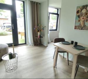 a living room with a table and chairs in a room at Boterbloem Bed en Brood in Hardenberg +6 photos