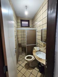 a bathroom with a toilet and a sink at durmaaquislz2 in São Luís +53 photos
