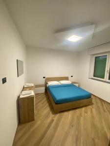 a bedroom with a bed and a wooden floor at Cantalupo30 in Cantalupo