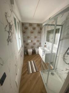 a bathroom with a shower and a sink and a mirror at Cantalupo30 in Cantalupo