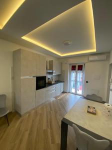 a living room with a table and a kitchen at Cantalupo30 in Cantalupo +19 photos