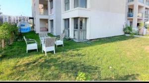 a group of chairs sitting in the yard of a building at Chalet Marina 2 Marassi in El Alamein