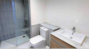 a bathroom with a toilet and a sink and a shower at Chalet Marina 2 Marassi in El Alamein +1 photo