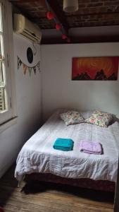 a bedroom with a bed with two towels on it at Casa Pugliese in Buenos Aires