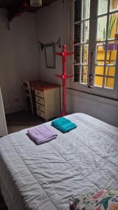 a bedroom with a bed and a dresser and a window at Casa Pugliese in Buenos Aires