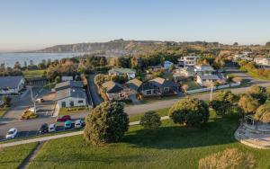 an aerial view of a small town next to the water at Handy Location, Ocean & Mountain Views, Close to Park - KK96845 in Kaikoura