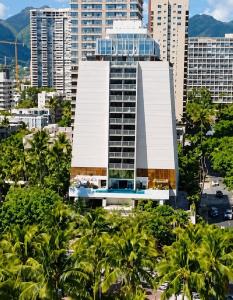 a tall building with a pool in front of a city at Hotel La Croix in Honolulu