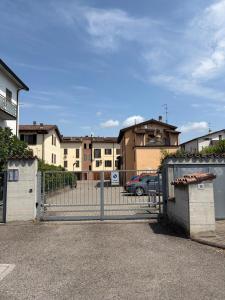 a gate in a parking lot with buildings in the background at Ambra House in Piacenza