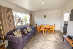 a living room with a couch and a table at Central, Affordable, Boat Parking - KK18865 in Kaikoura
