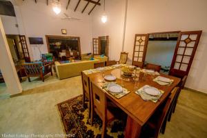 a large wooden table in a living room at Serendipity Lake Villa in Panadura