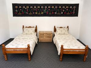 two beds sitting next to each other in a room at Muso guesthouse in Yukary-Ukhum