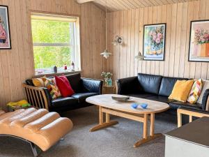 a living room with couches and a coffee table at 4 star holiday home in Tarm in Tarm