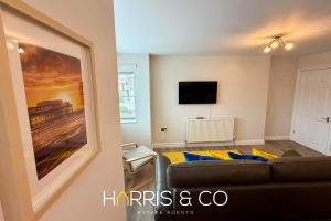 a living room with a couch and a painting on the wall at Upper Marsh Apartment in Thornton