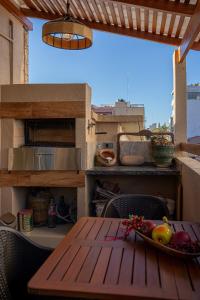 a table with a bowl of fruit on a balcony at Casita Vera Style in Tarija