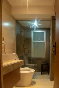 a bathroom with a toilet and a glass shower at Casita Vera Style in Tarija +48 photos