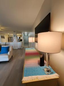 a living room with a lamp and a couch at 1315 Pelican Watch Villas-Beachfront & Amenities - on Sale in Seabrook Island +66 photos