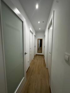 a hallway with white walls and a glass door at O LAR DE DON BASILIO in Redondela +23 photos