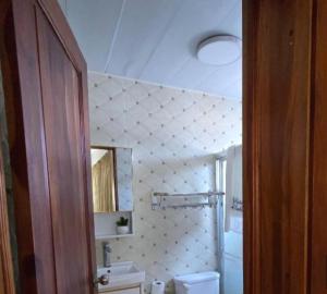 a bathroom with a toilet and a sink and a mirror at Casa Same Hotel in Atacames +12 photos