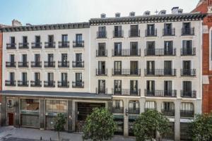 a large white building with windows and balconies at AmazINN Collection Madrid Plaza Mayor in Madrid