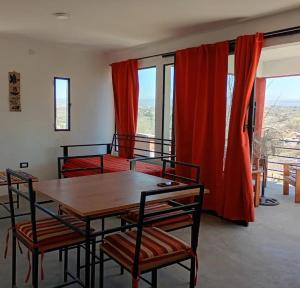 a room with two bunk beds and a table and chairs at Cabañas La Puesta del Sol in Estancia Vieja +11 photos