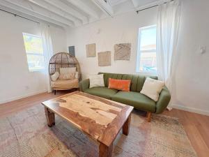 a living room with a green couch and a coffee table at Pet-Friendly Near Zion & Hot Tub in Downtown Kanab in Kanab