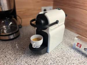 a coffee maker sitting on a counter with a cup of coffee at Sauna Chalet Ahorn in Bad Kleinkirchheim
