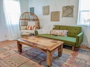 a living room with a green couch and a coffee table at Pet-Friendly Near Zion & Hot Tub in Downtown Kanab in Kanab +69 photos