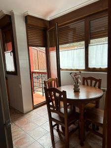 a dining room with a wooden table and chairs at Remoña 2 in Espinama