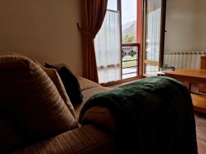 a living room with a couch and a large window at Remoña 2 in Espinama +41 photos