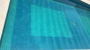 a swimming pool with blue tiles on the side of it at Casa Victoria in Colima