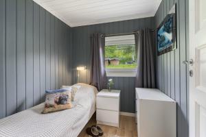 a small bedroom with two beds and a window at Kvila in Surnadal