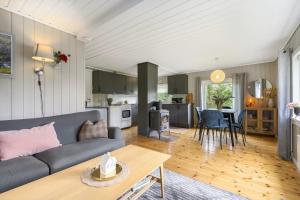 a living room with a couch and a table at Kvila in Surnadal